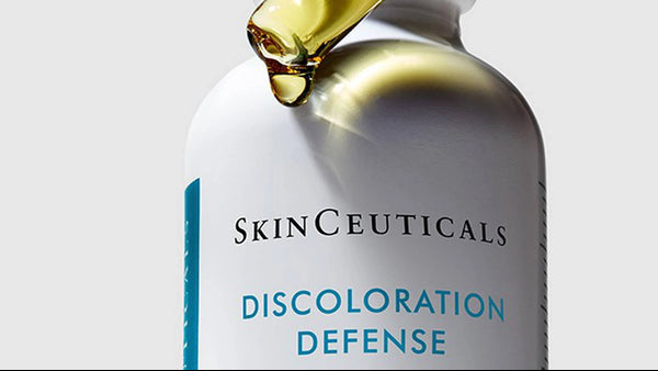 SkinCeuticals Discoloration Defense serum bottle with dropper on a light gray background
