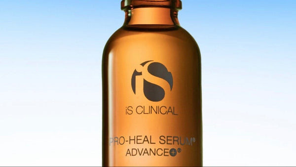 IS Clinical Pro-Heal Serum Advance bottle with dropper on a blue gradient background