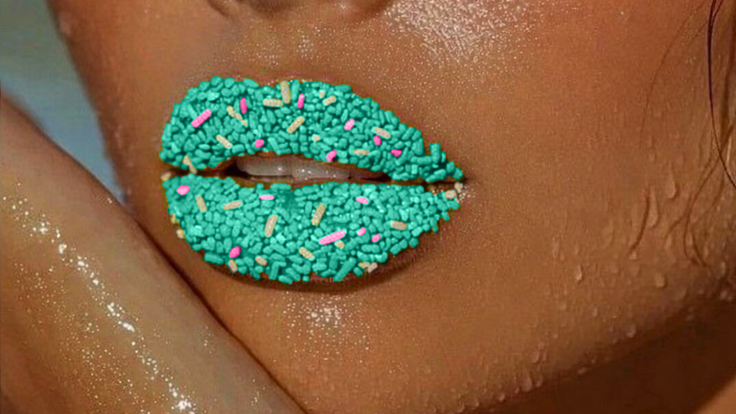Close-up of a person with glittery green lipstick and sun-kissed skin.