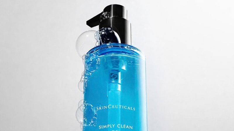 Blue bottle of SkinCeuticals Simply Clean Gel on a light gray background